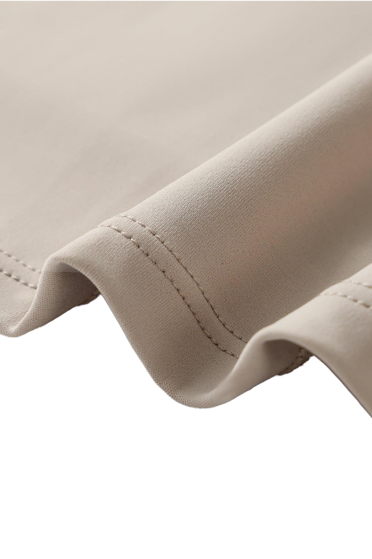 Close-up of beige fabric with a focus on stitching detail