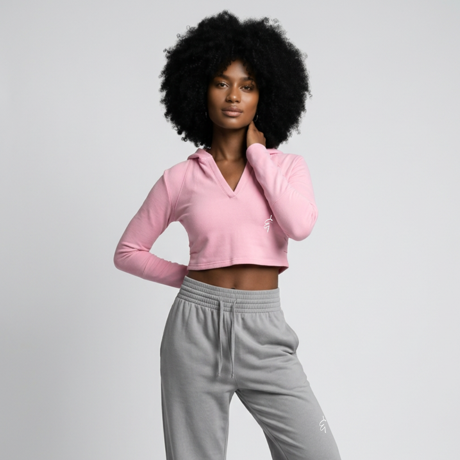 A soft pink long-sleeved knit top with ribbed texture and enjoy and appreciate embroidery on the back side in athleisure collection