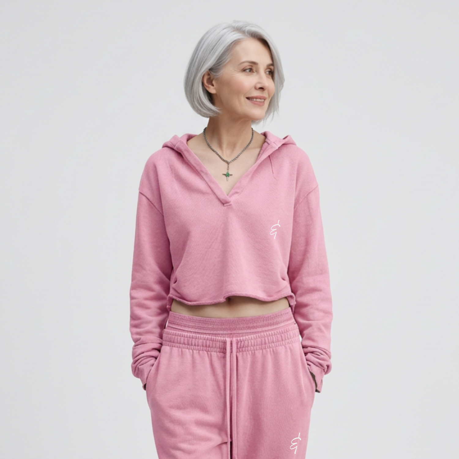Woman wearing a pink tracksuit with a plain background
