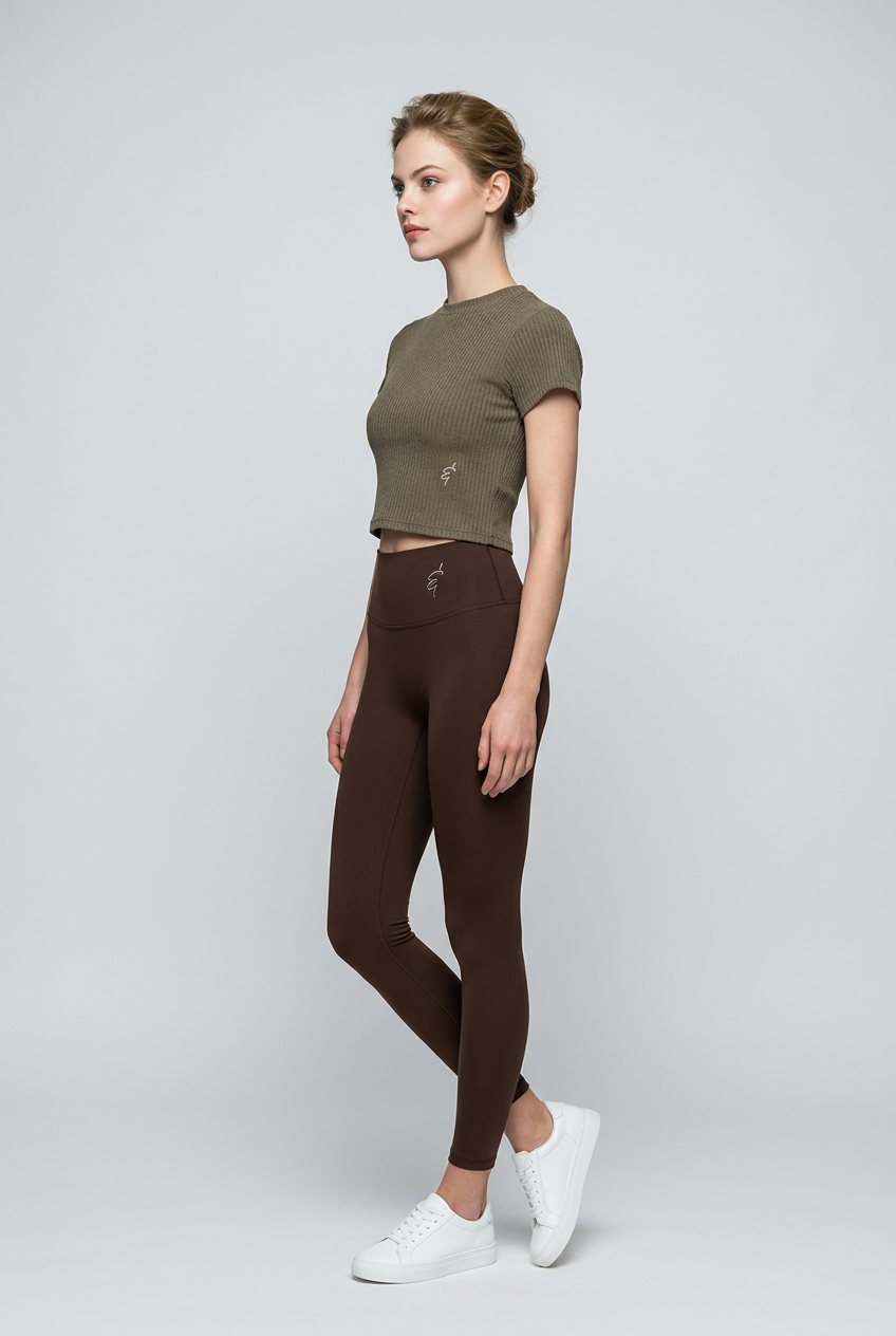 Olive ribbed crop top with a small logo on the left side paired with seamless high-waisted activewear leggings