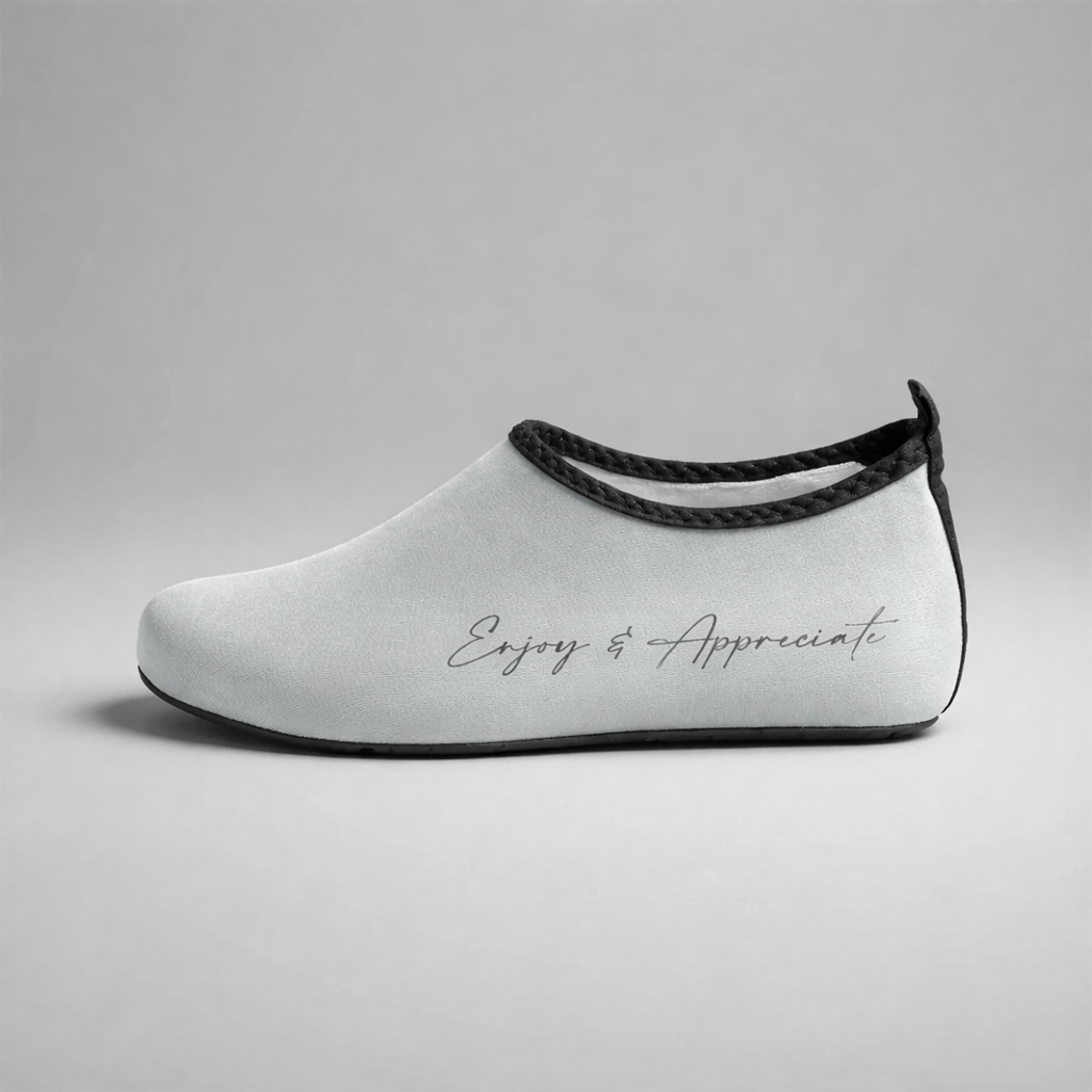 grey slip-on barefoot intention aqua water shoe with black trim and enjoy & appreciate gray script embroidery