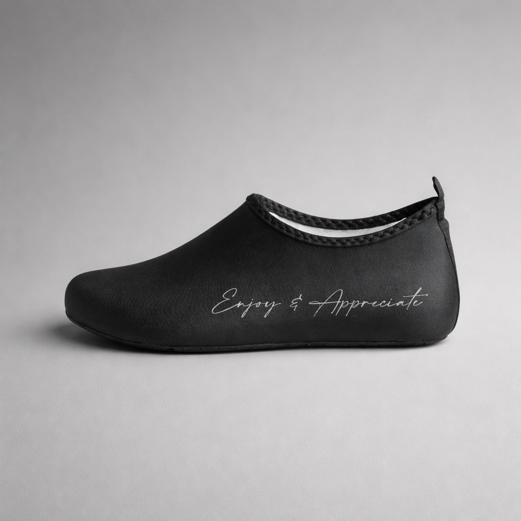 Black water shoe with sleek slip on design and silver embroidered enjoy & appreciate on side aqua shoes barefoot intention