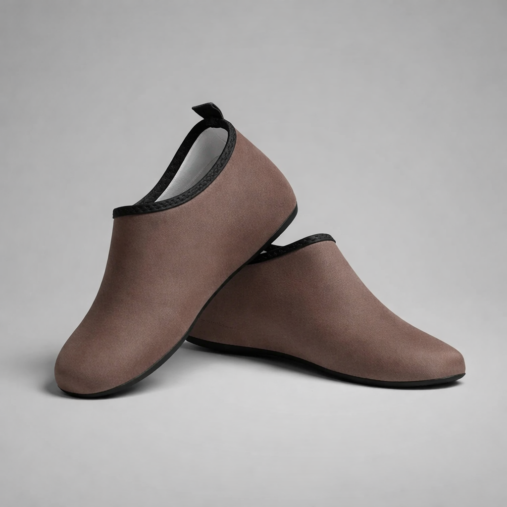 Brown slip-on aqua shoes with black trim and rubber soles designed for barefoot intention water activities