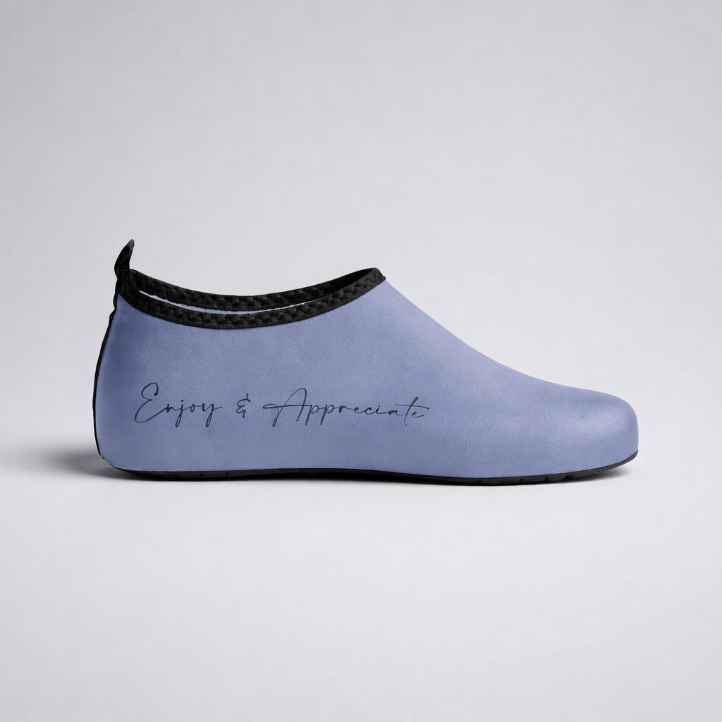 Light blue rubber slip-on aqua shoes with black braided trim and enjoy and appreciate embroidery for barefoot intention