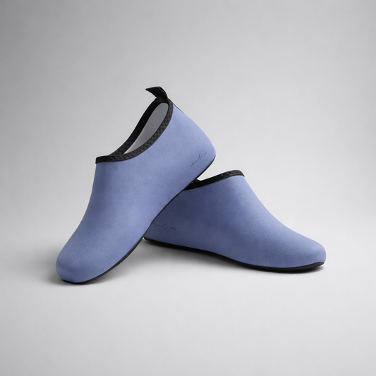 Light blue neoprene aqua shoes with black trim and soft flexible design by Barefoot Intention