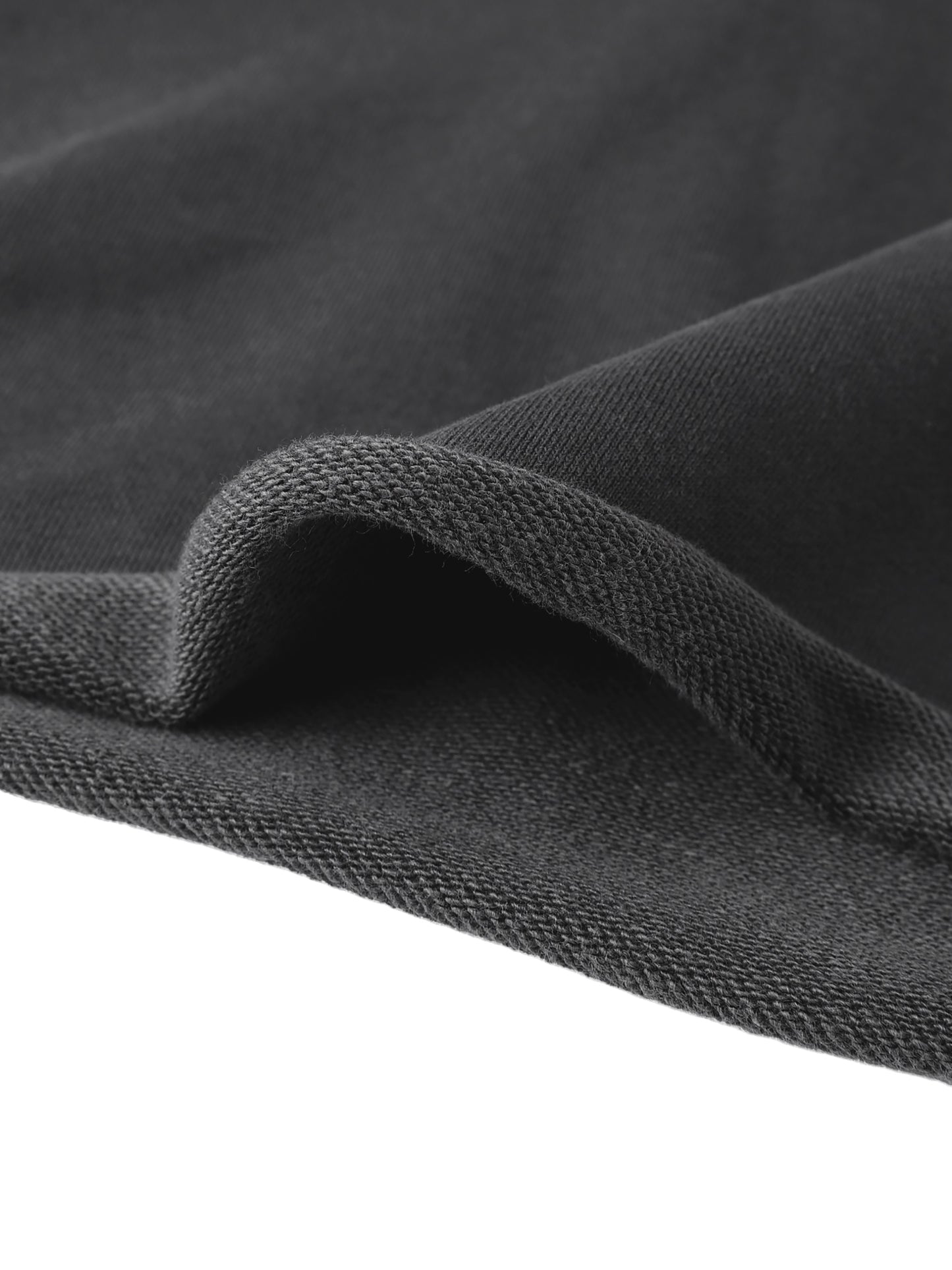 Black textured knit fabric with a soft fuzzy surface for cropped raw edge hoodie material detail