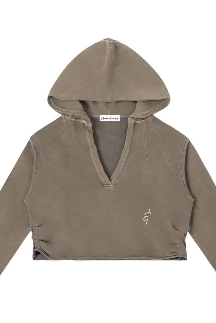 A taupe cropped raw edge hoodie with v-neckline ribbed cuffs hem and small embroidered logo on left chest