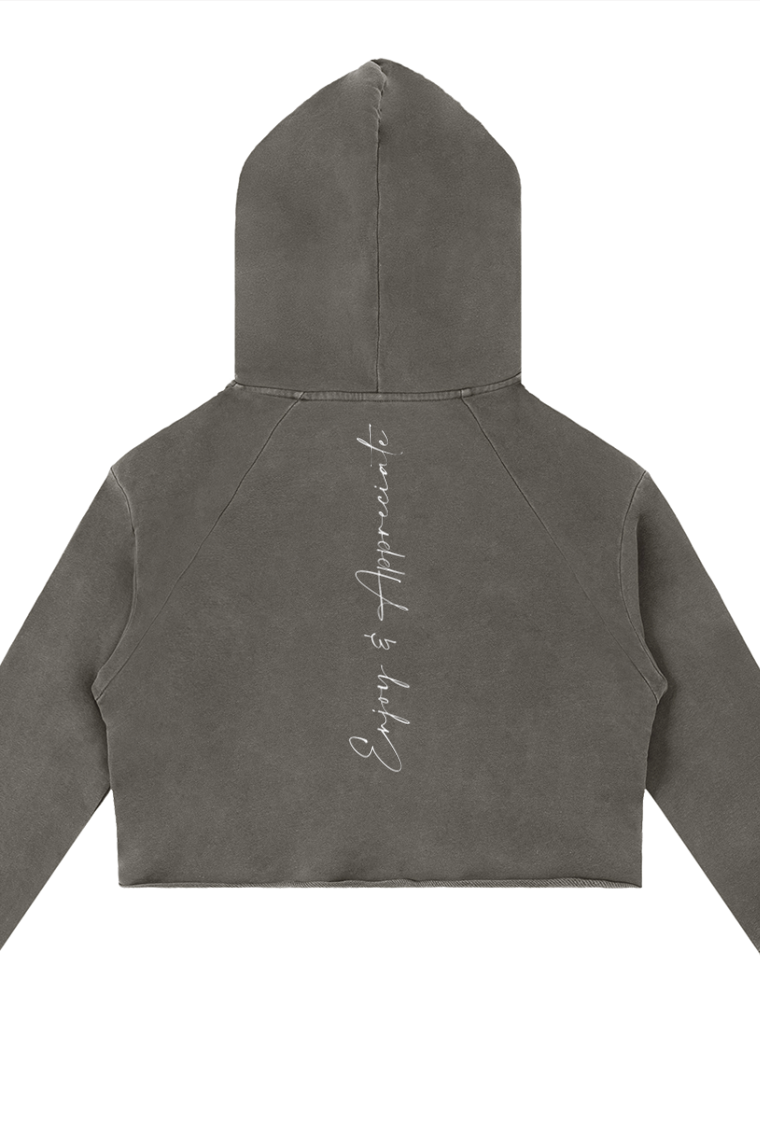 Back of a dark gray cropped raw edge hoodie with faded texture and enjoy and appreciate embroidered in white cursive