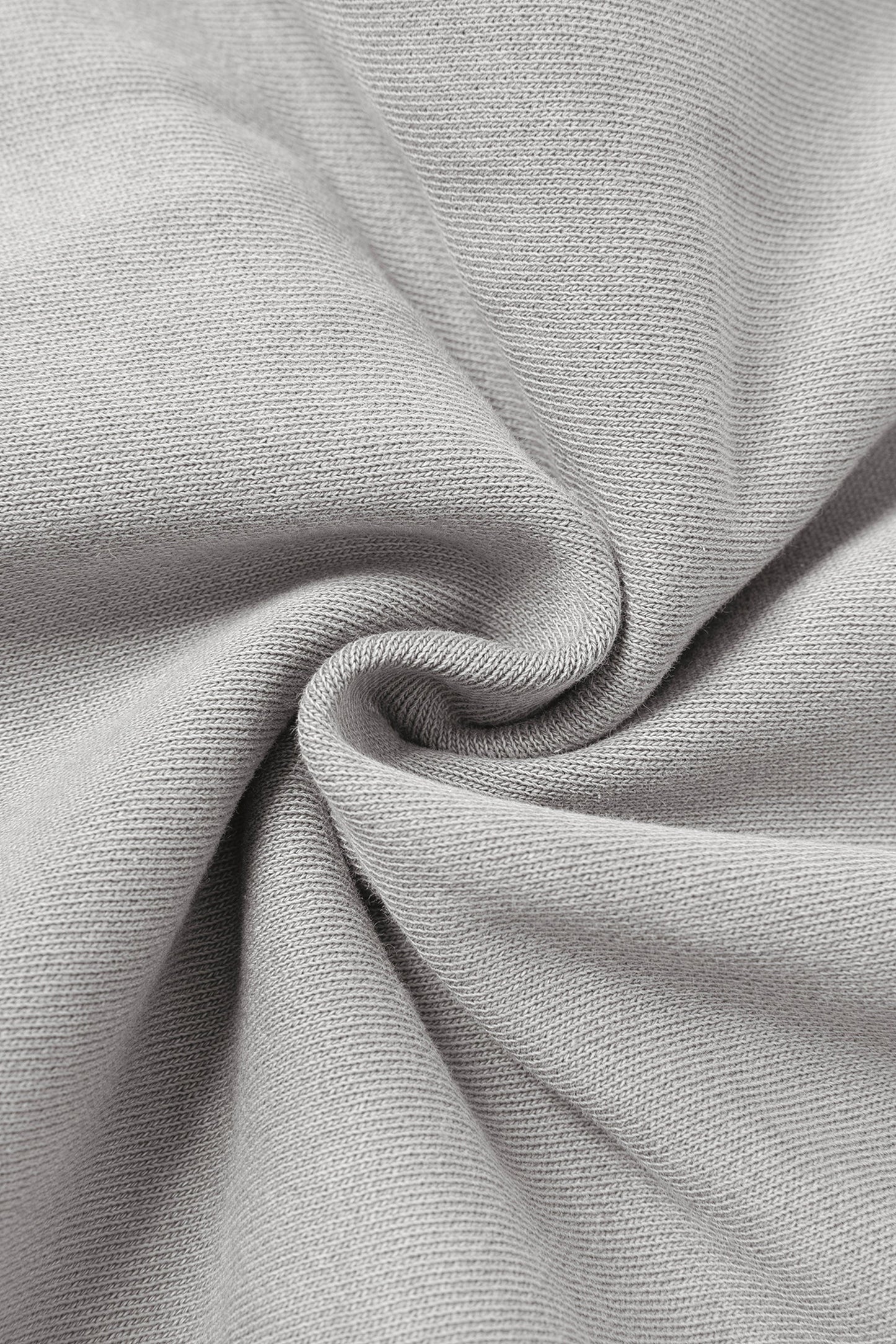 Close up of light grey fabric in a swirl shape