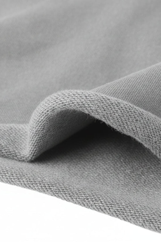 Gray knit cropped hoodie fabric with soft textured weave and ribbed edge for comfortable casual wear
