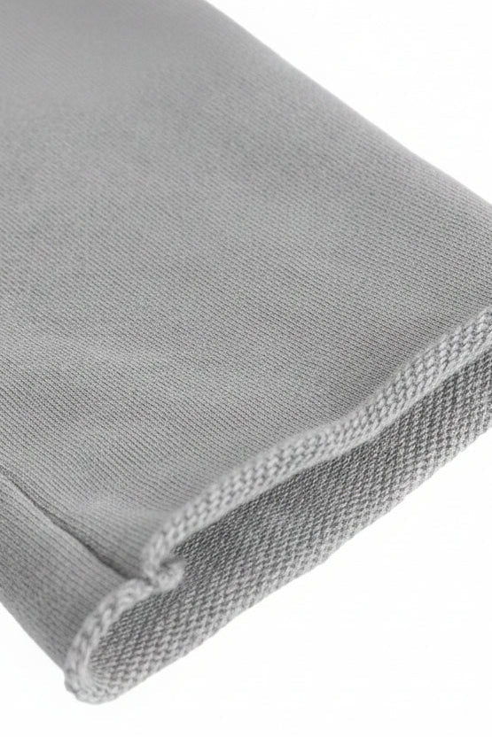 Gray microfiber cleaning cloth with soft textured weave and finished edges shown with cropped hoodie product