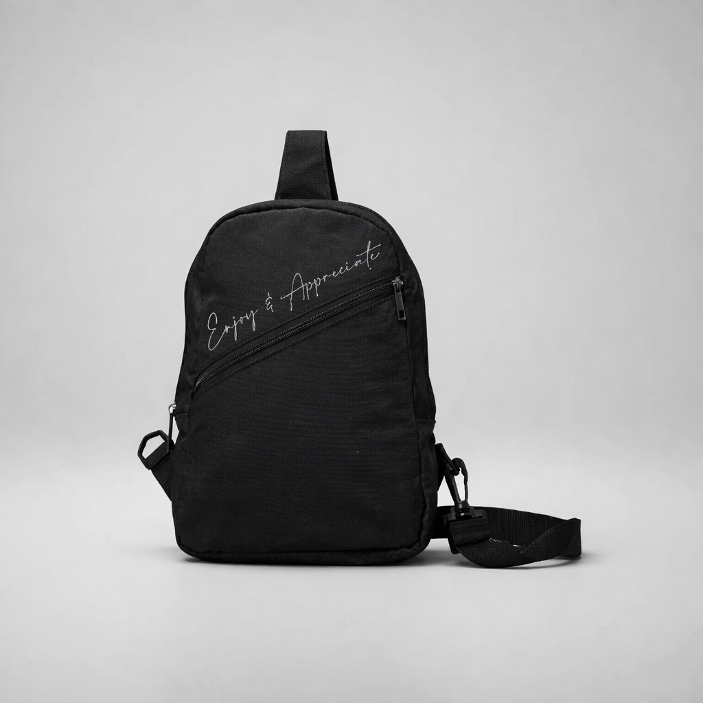 Black nylon crossbody bag with enjoy and appreciate embroidered in silver script for everyday use