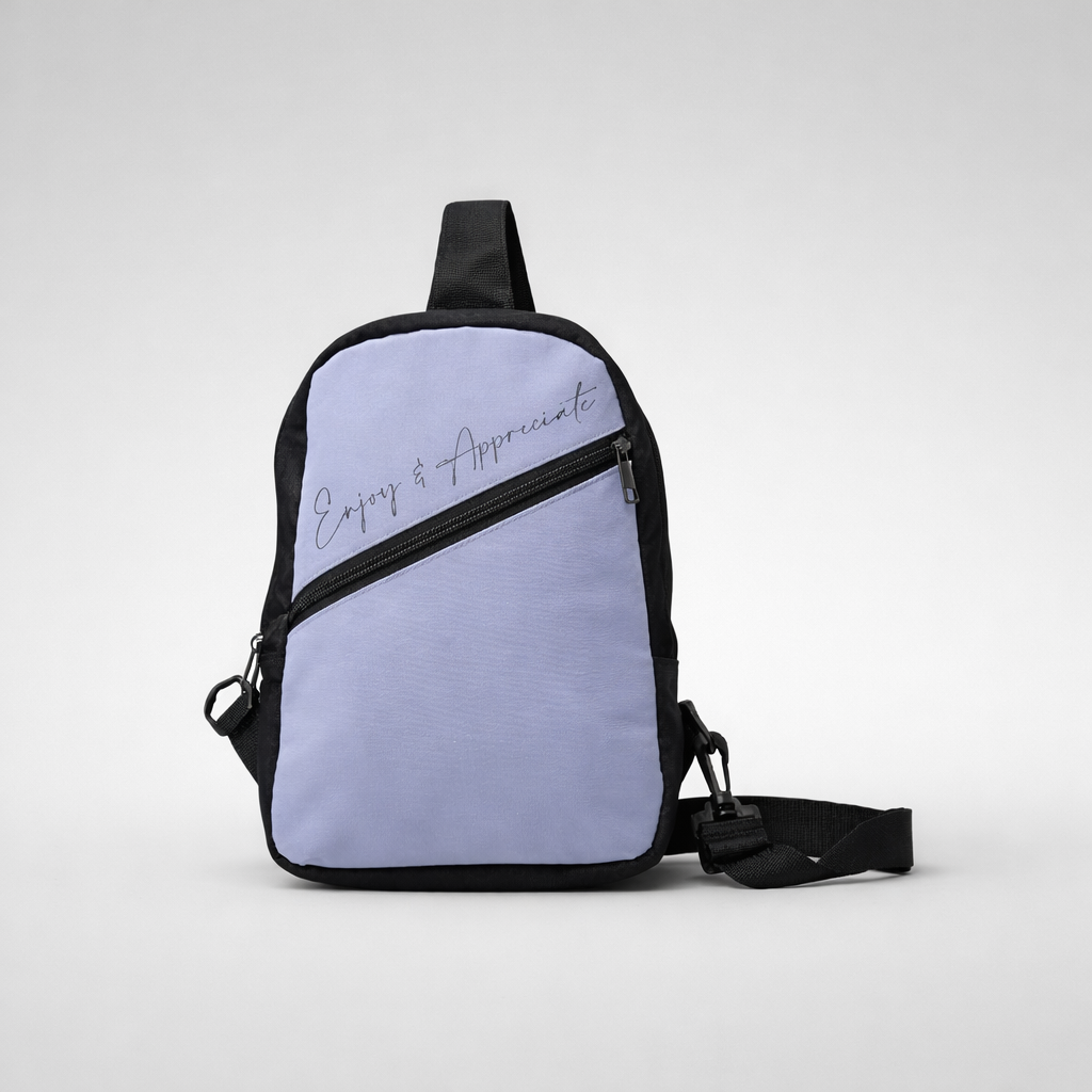 Light purple and black crossbody bag with enjoy and appreciate scripted in silver on front for casual use