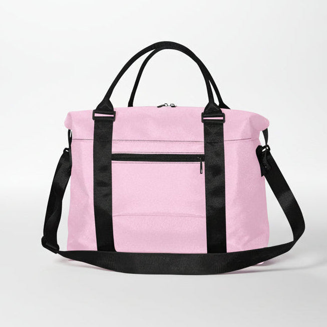 Pink duffel bag with black handles and shoulder strap designed for versatile travel and gym use