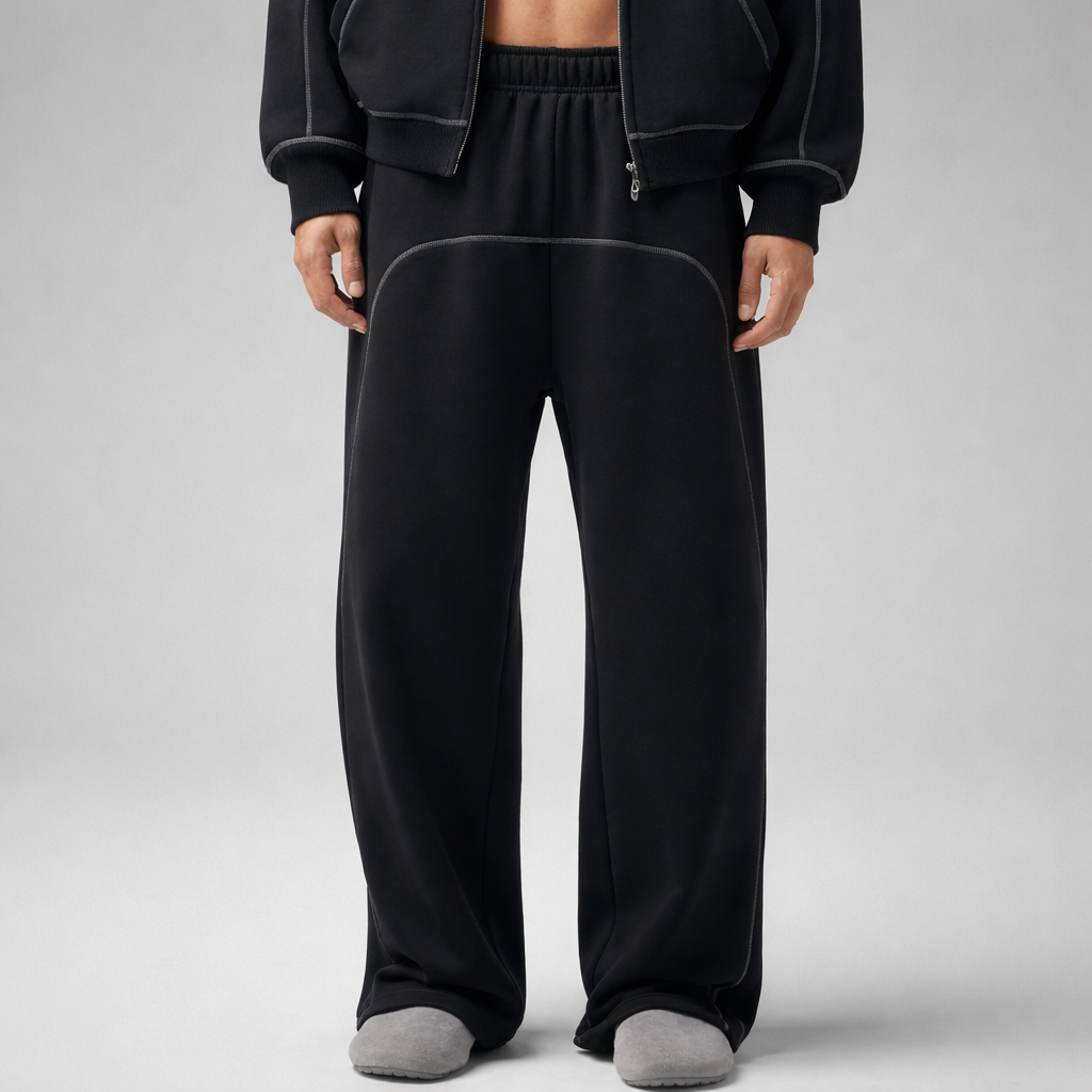 Person wearing black sweatpants with white line on a gray background