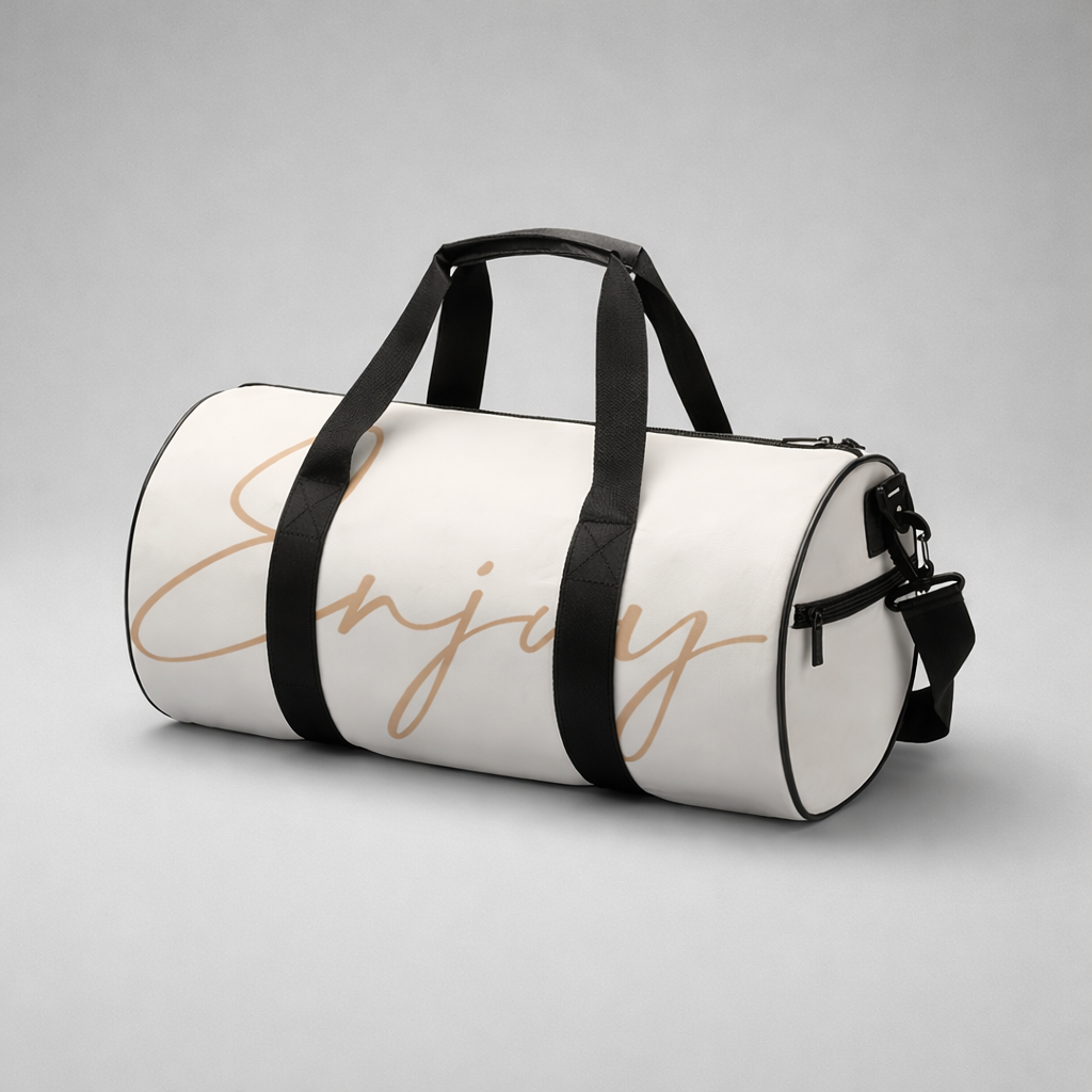 White gym duffel bag with black straps and gold cursive enjoy lettering ideal for workout and travel