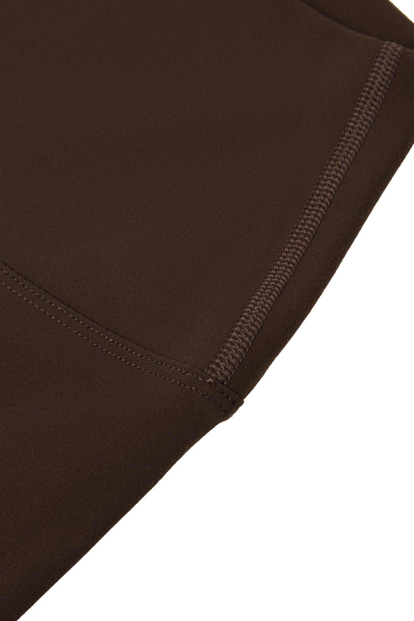 Close-up of brown fabric with a visible seam on a white background