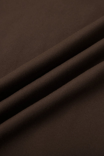 Close-up of dark brown fabric with folds