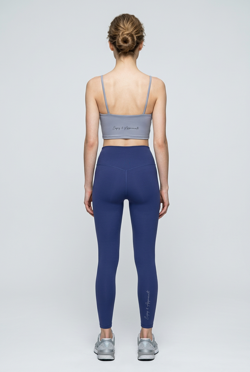 Back view of gray and navy blue seamless high-waisted activewear leggings and sports bra with cursive branding