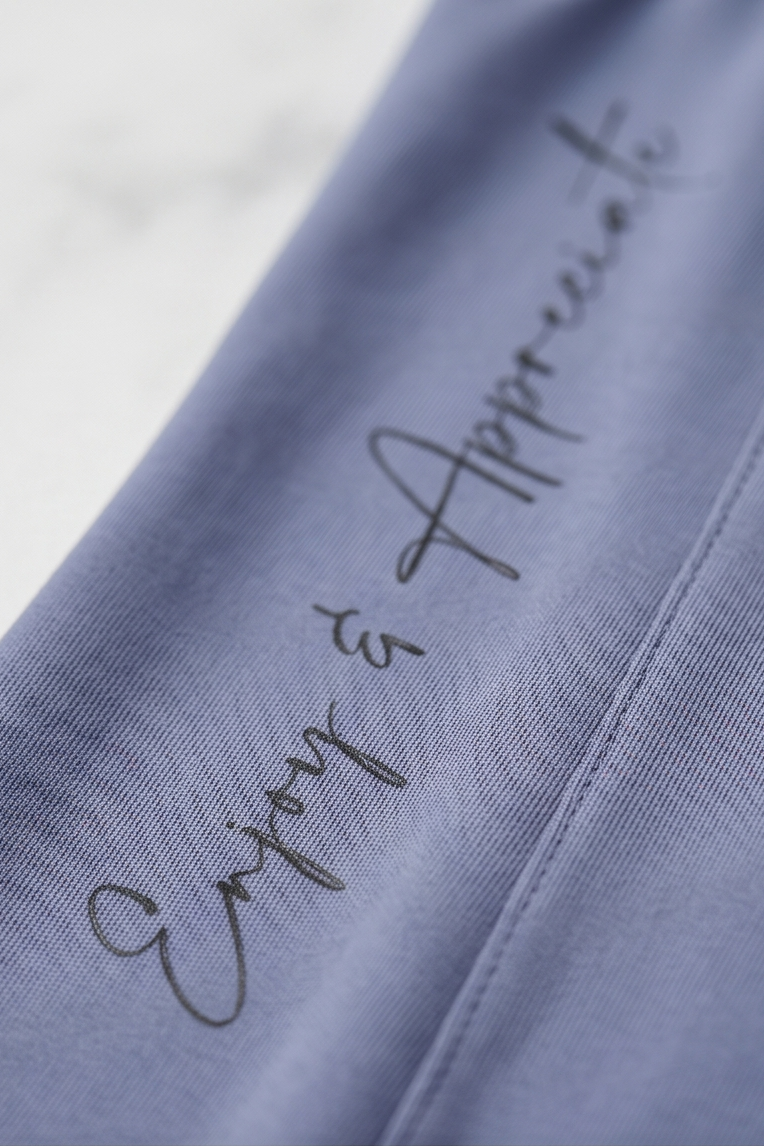 Blue fabric with 'Enjoy & Appreciate' text on a light gray background