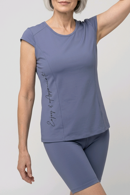 Woman wearing the Lilliroa T-shirt in Ice Silk in Moonlight Haze, front view, with Enjoy & Appreciate print