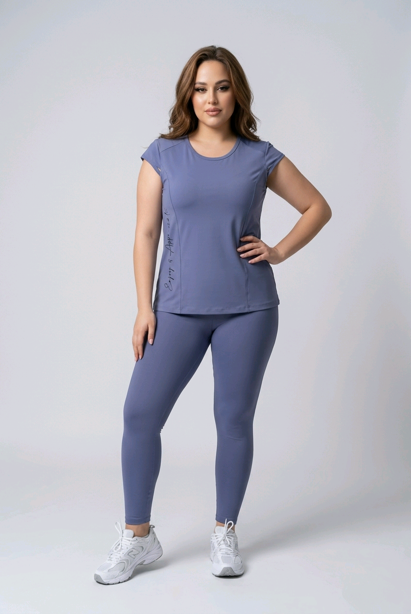 Woman wearing a matching blue t-shirt and leggings set on a white background