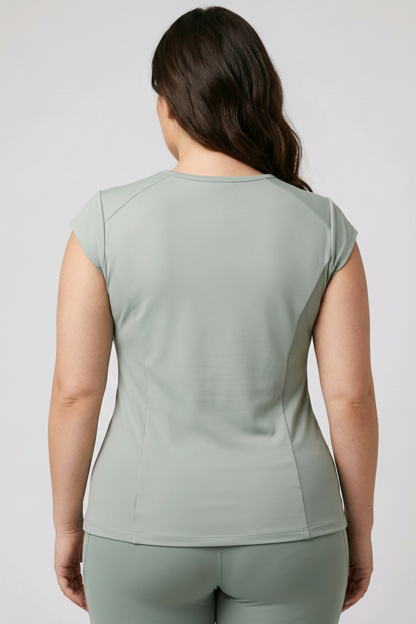 Woman wearing a green athletic outfit on a plain background