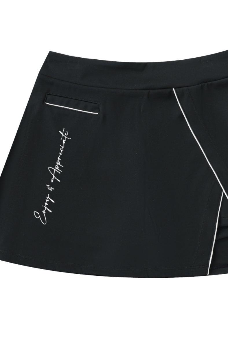 Black skirt with white piping and text of Enjoy & Appreciate on a plain white background