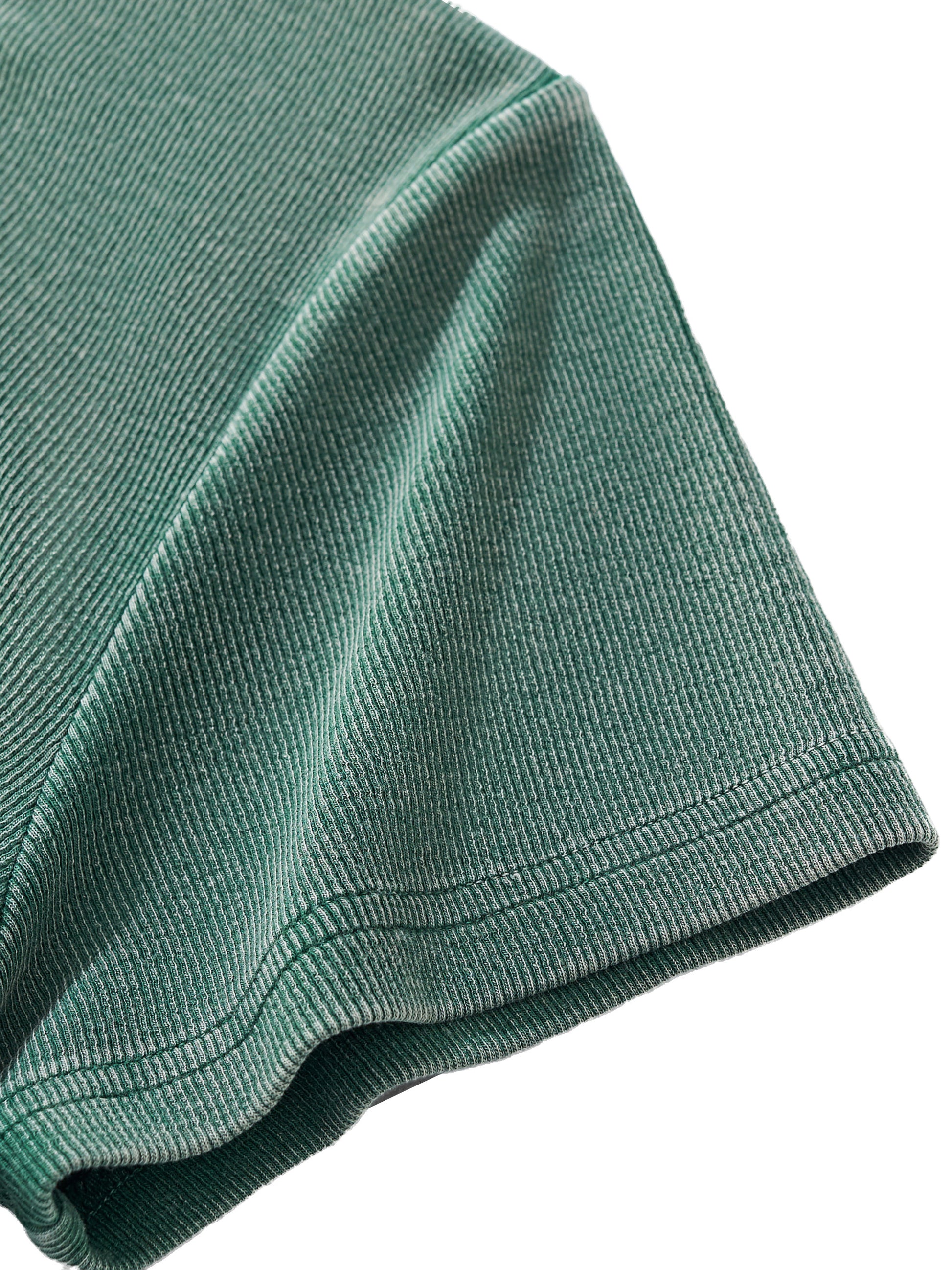 Close-up of a green sleeve textured fabric on a white background