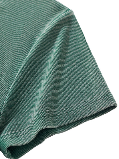 Close-up of a green sleeve textured fabric on a white background