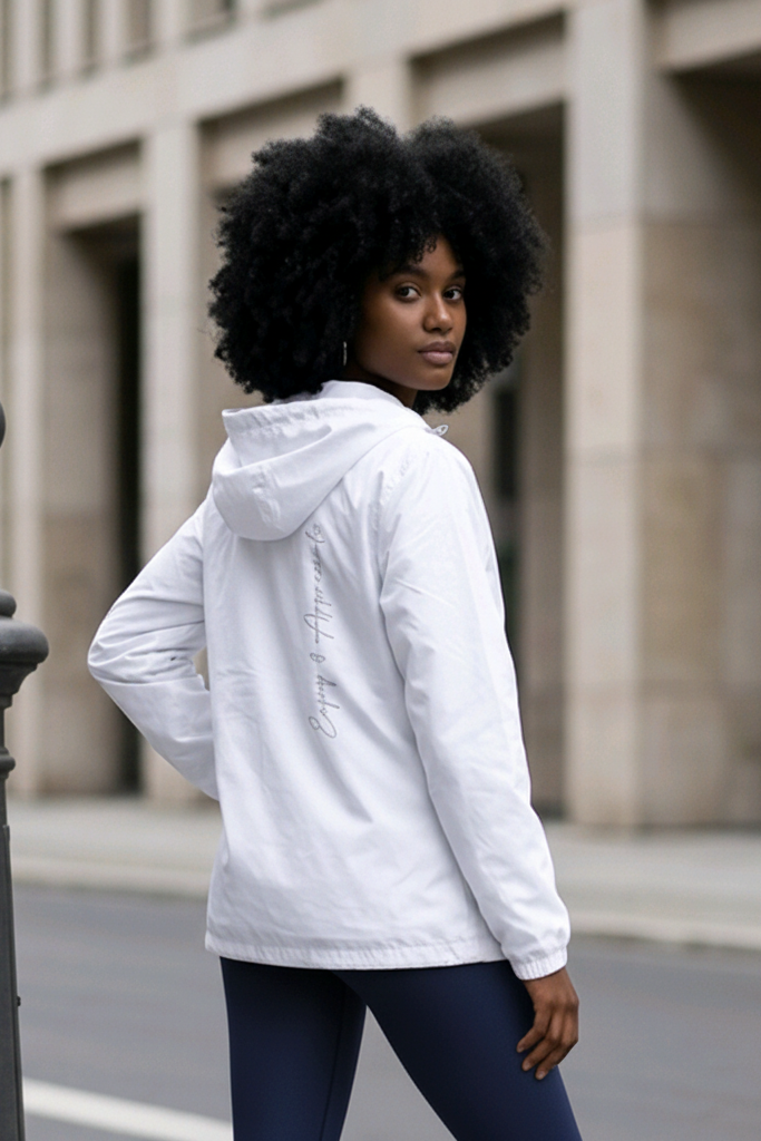 Back view of lightweight white hooded sports jacket with subtle cursive script design along the back seam