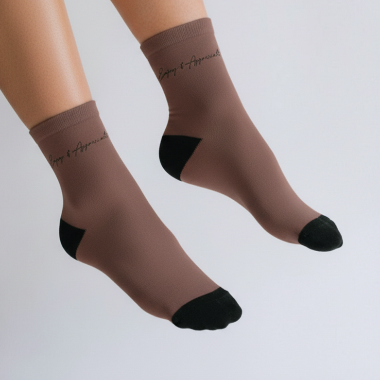 Brown sheer ankle socks with black toe and heel accents and enjoy and appreciate embroidered on the cuff