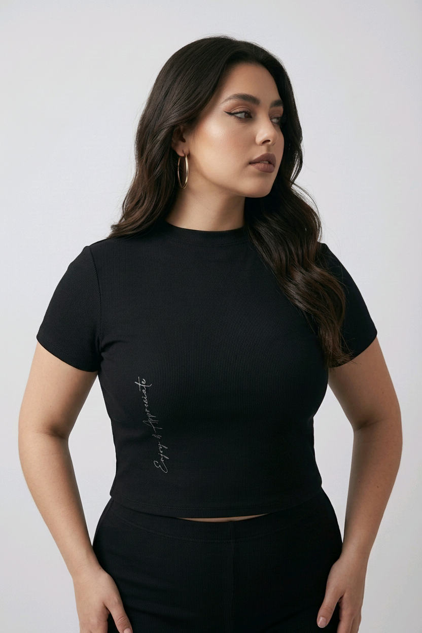 Woman wearing a black mock neck t-shirt with text on a plain background