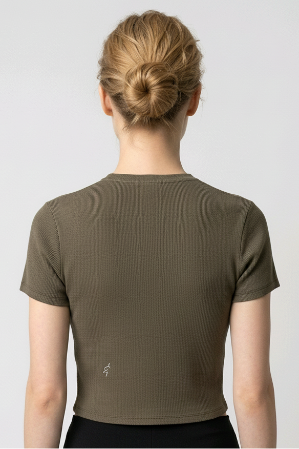 Woman wearing a green gray t-shirt and black leggings on a white background