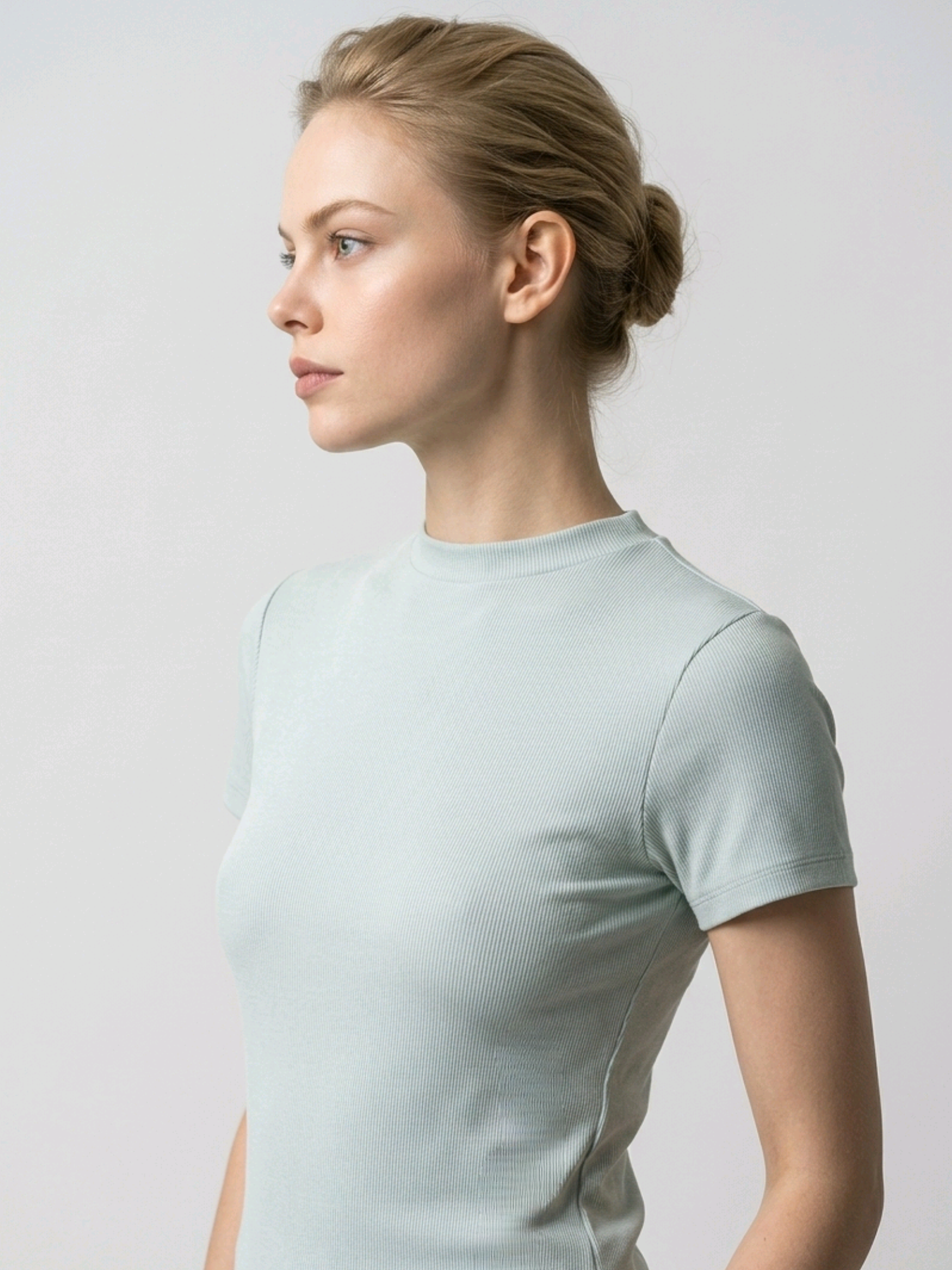 Woman wearing a light blue t-shirt against a plain background