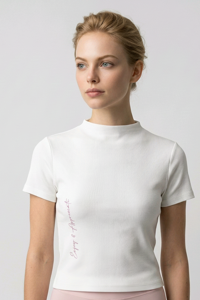 Woman wearing a white t-shirt with text on a plain background