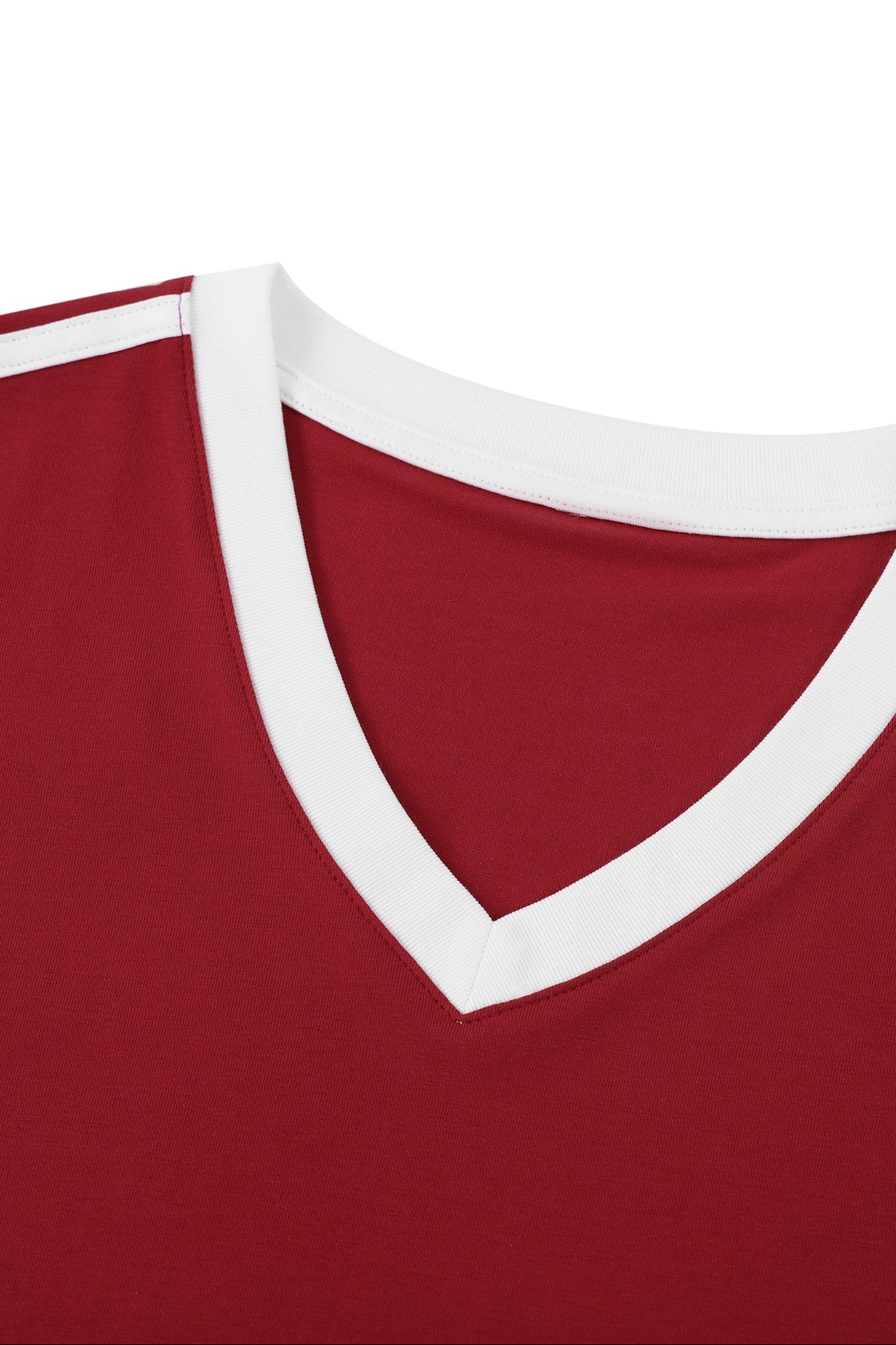 Close-up of a red V-neck athletic jersey with a contrasting white ribbed collar and white shoulder stripes.