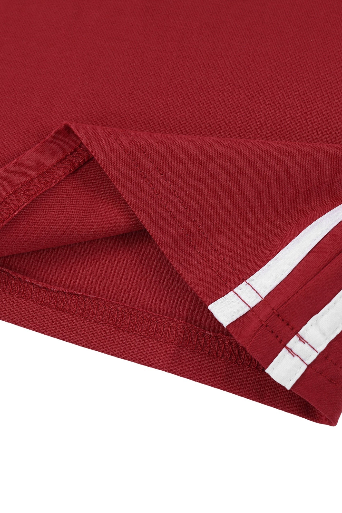 Close-up of a red fabric product, likely a sweatshirt sleeve or garment hem, folded to show stitching and two white stripes near the cuff, on a white background.