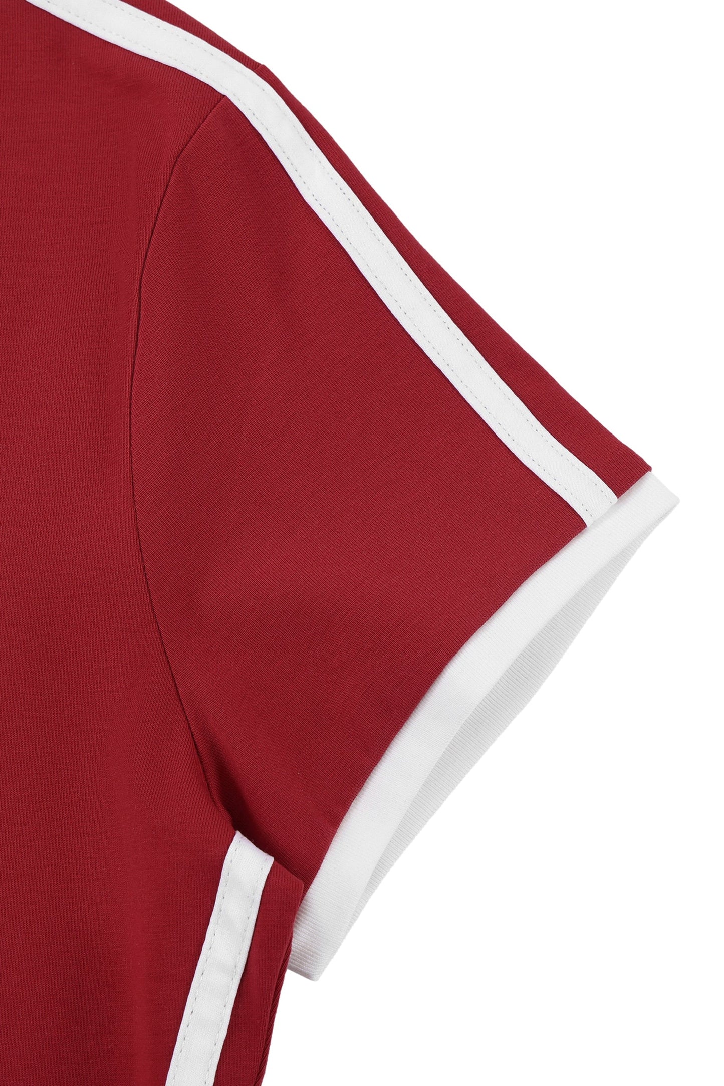 Close-up of a short-sleeve red top with white contrast piping along the sleeve and neckline, shown on a white background.