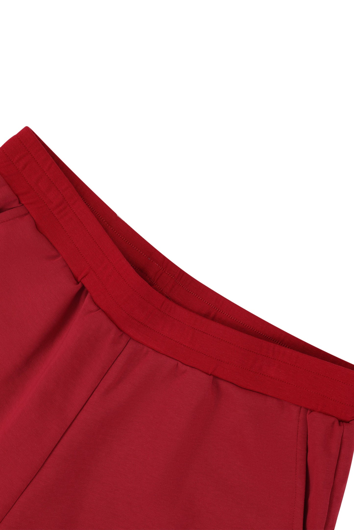 Close-up of a red garment waistband with a white background