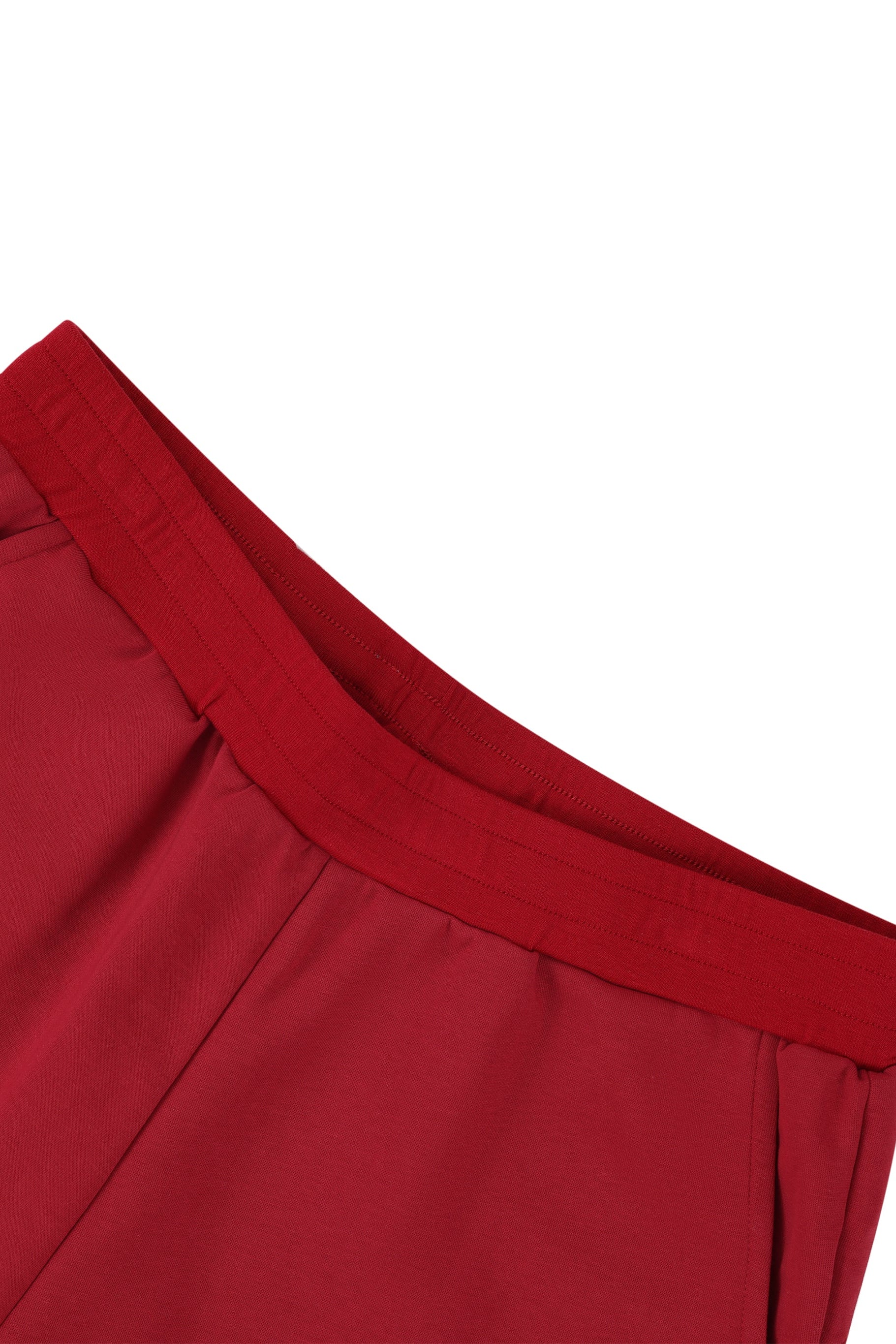 Close-up of a red garment waistband with a white background