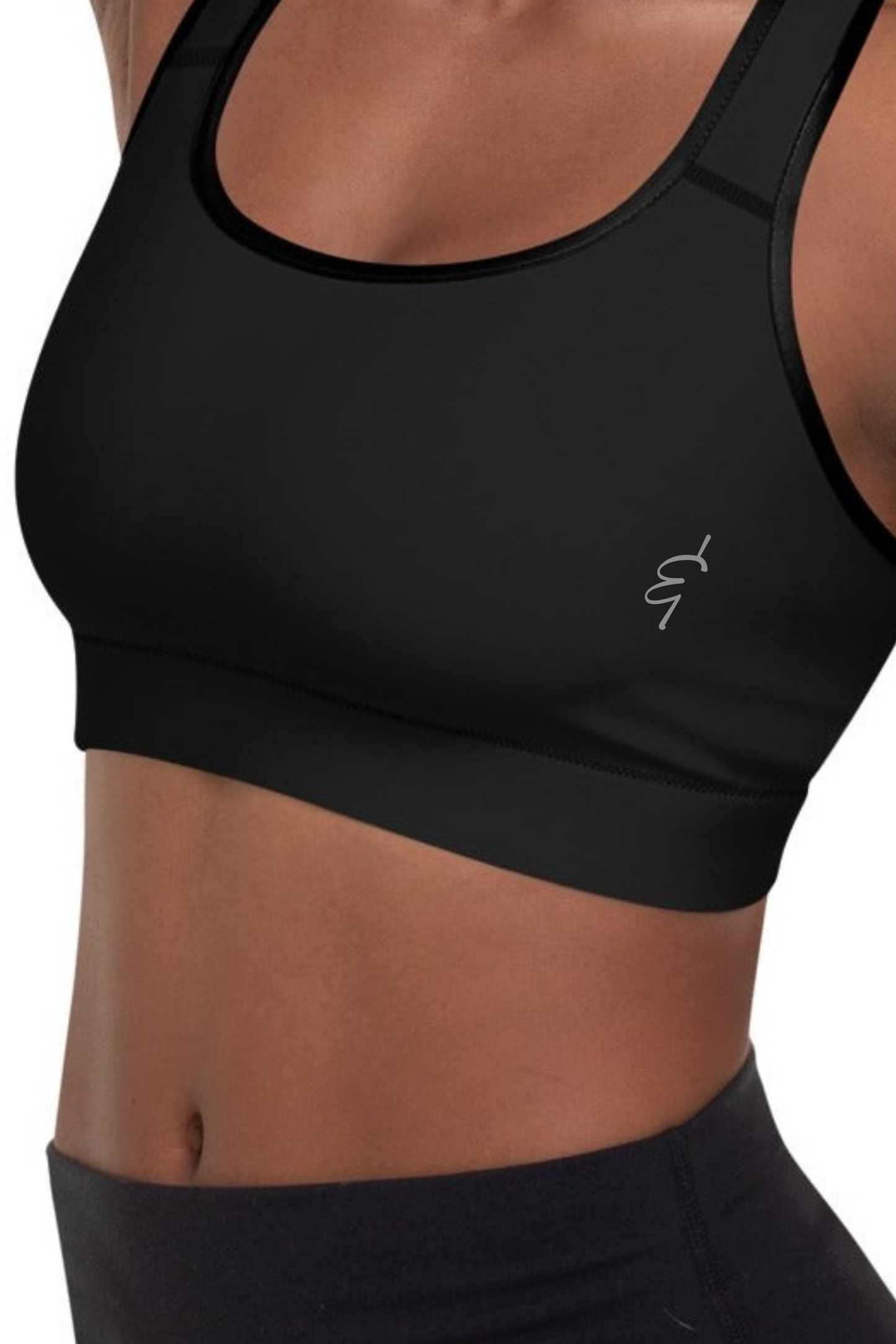 Black racerback sports bra with subtle silver logo on the chest designed for high impact workouts