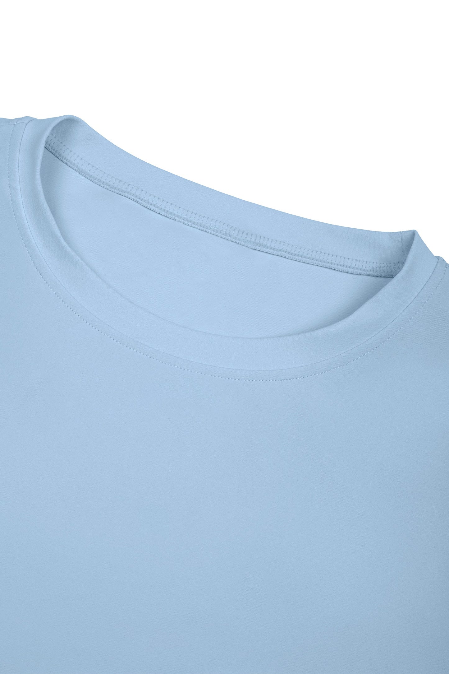 Close-up of a light blue t-shirt with a plain background