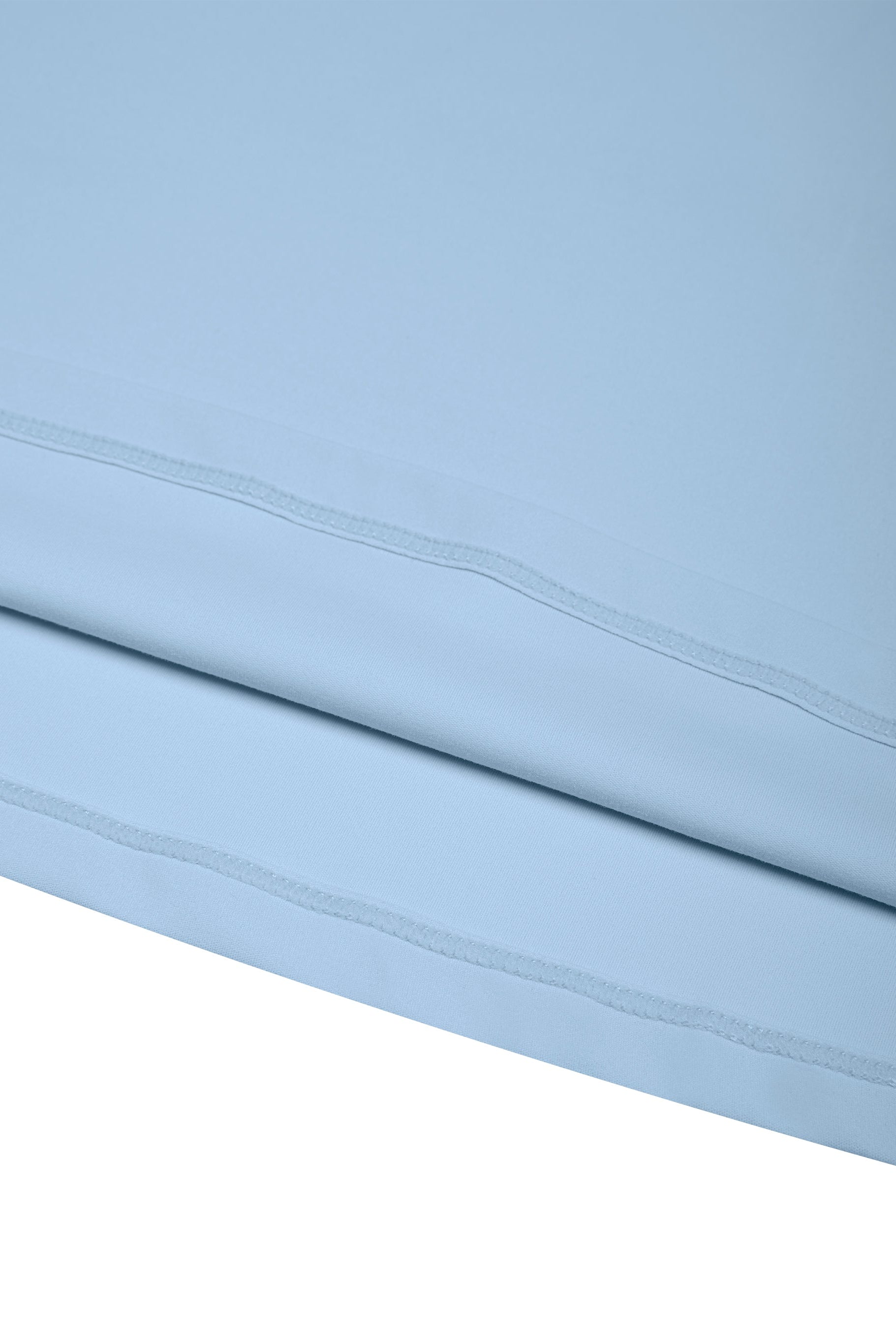 Light blue fabric with a subtle pattern on a white background