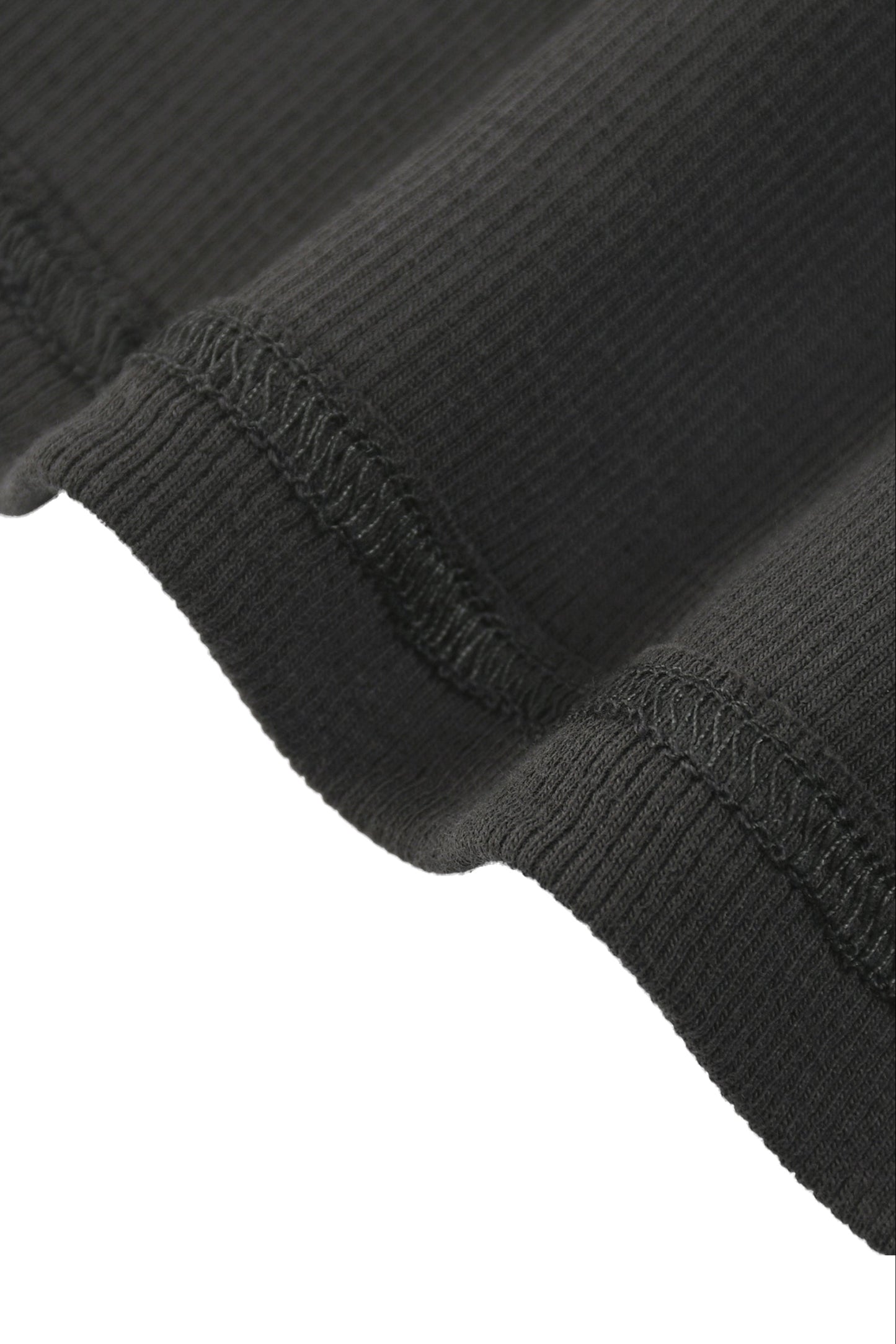 Tank top with racerback in black ribbed knit fabric featuring textured stretchy material and visible seam stitching