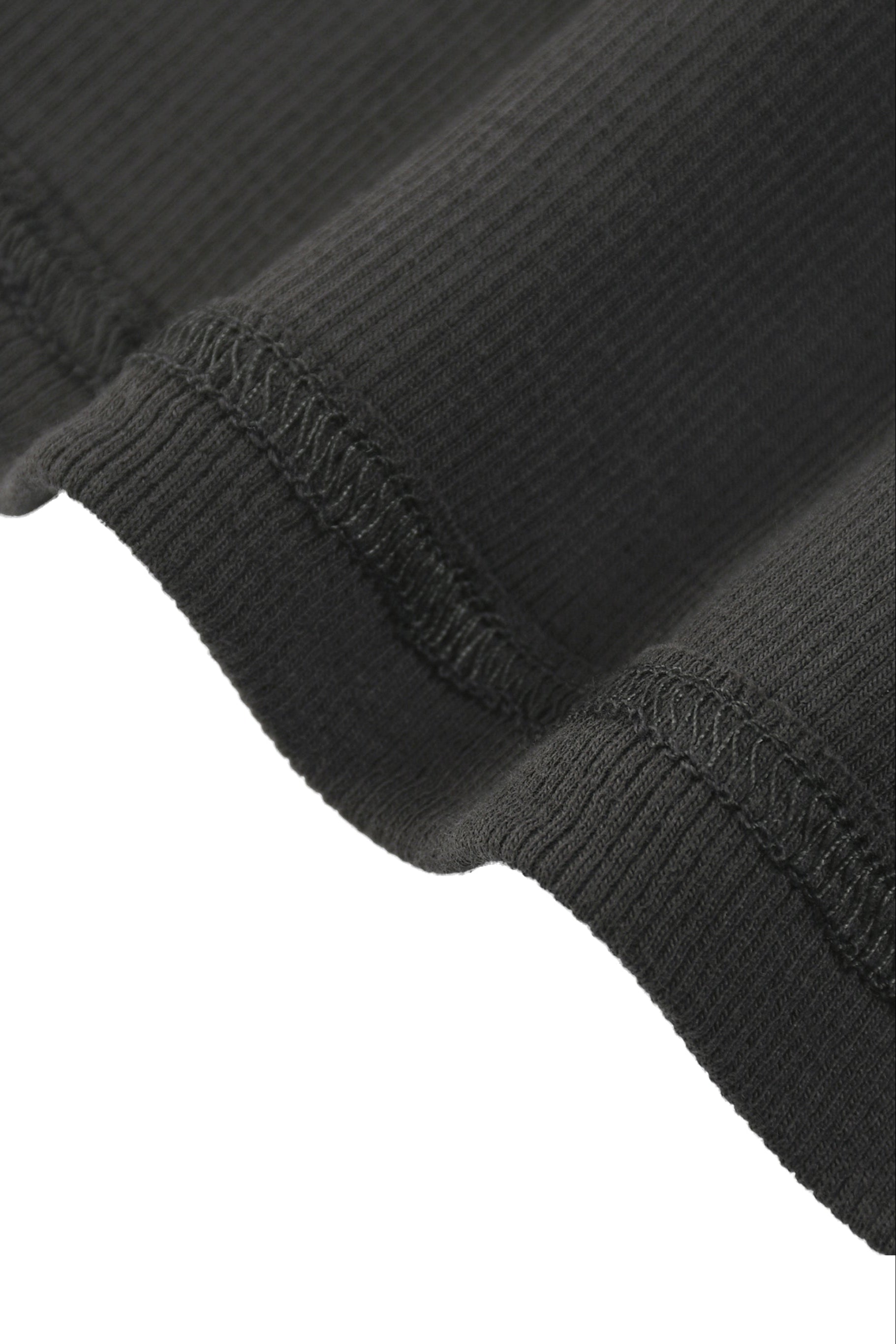 Tank top with racerback in black ribbed knit fabric featuring textured stretchy material and visible seam stitching