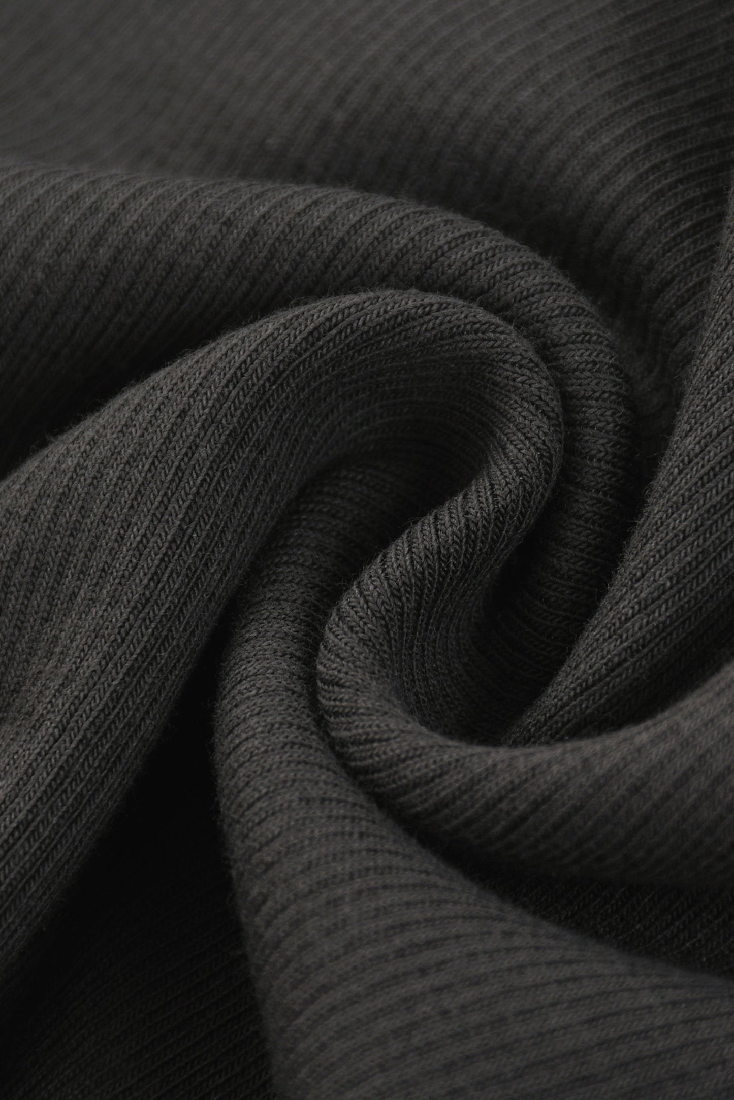 Dark gray ribbed knit fabric of a tank top with racerback showing its soft textured surface