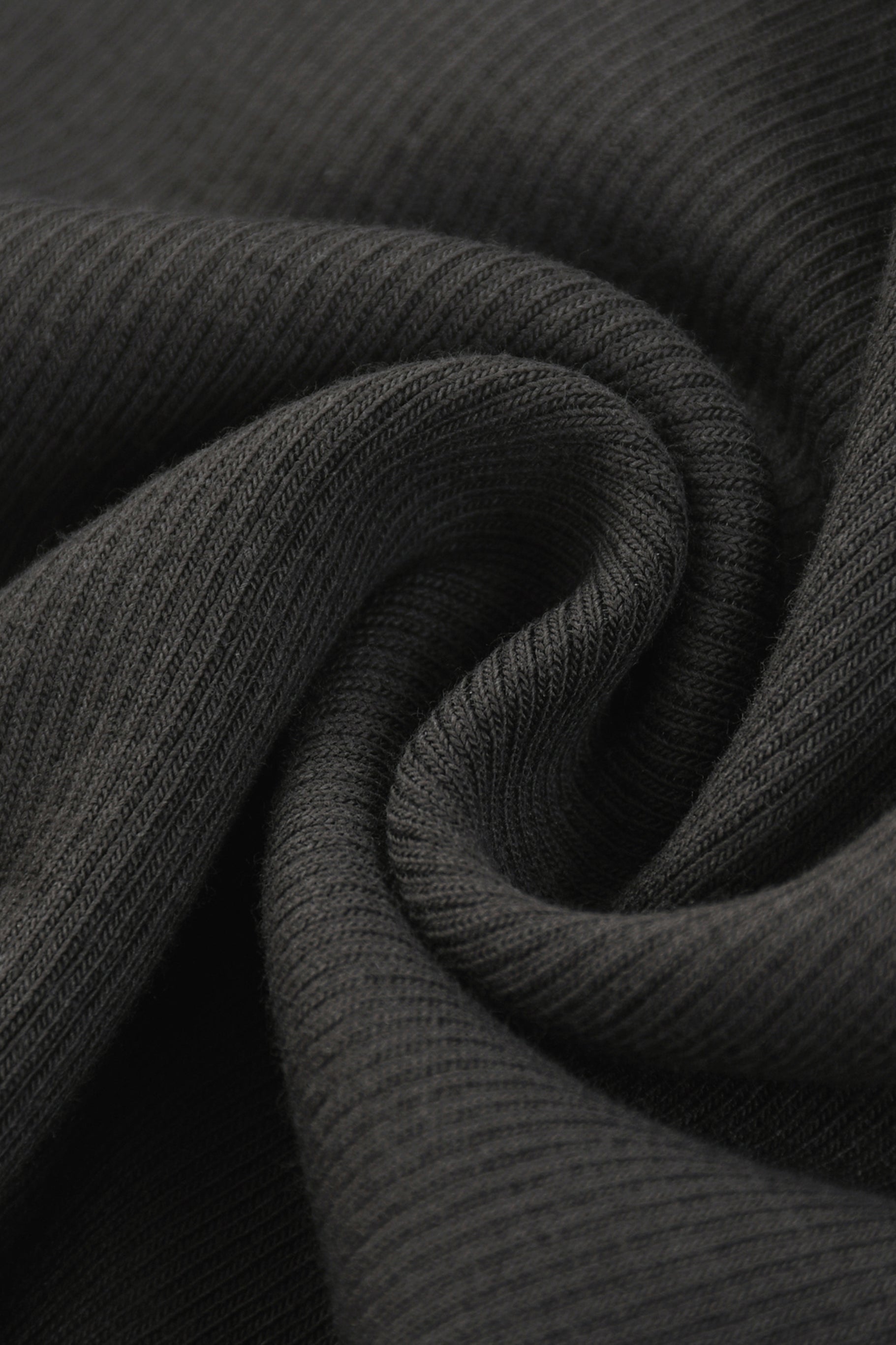 Dark gray ribbed knit fabric of a tank top with racerback showing its soft textured surface