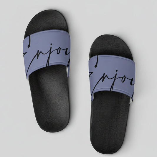 Slip-on sandals featuring black and lavender slide design with a cursive enjoy strap for casual wear