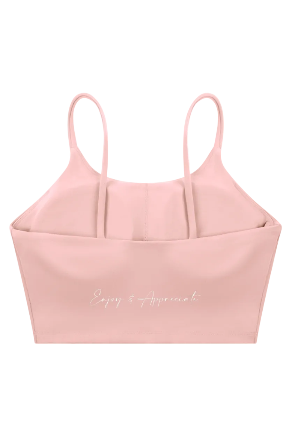 A soft pink form-fitting sports bra with thin spaghetti straps and silver text enjoy and appreciate script on front